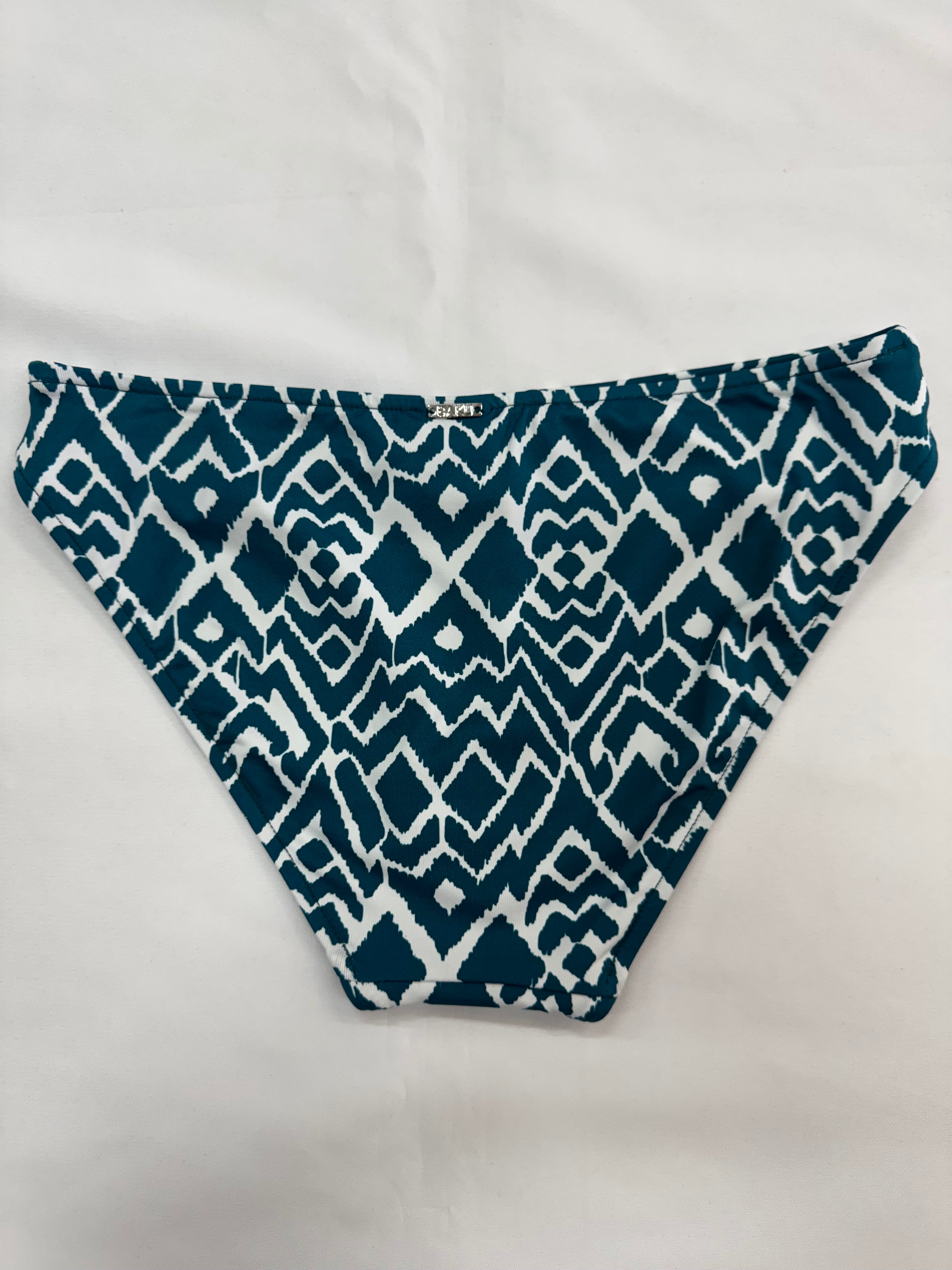 La Selva, is our captivating Ikat print that blends traditional craftsmanship with modern flair. This geometric design features intricate patterns, masterfully woven into shapes that evoke the untamed beauty of the jungle, making La Selva the perfect choice for swimwear that stands out with timeless elegance and a touch of adventurous spirit. Dive into style with La Selva, where tradition meets trend.