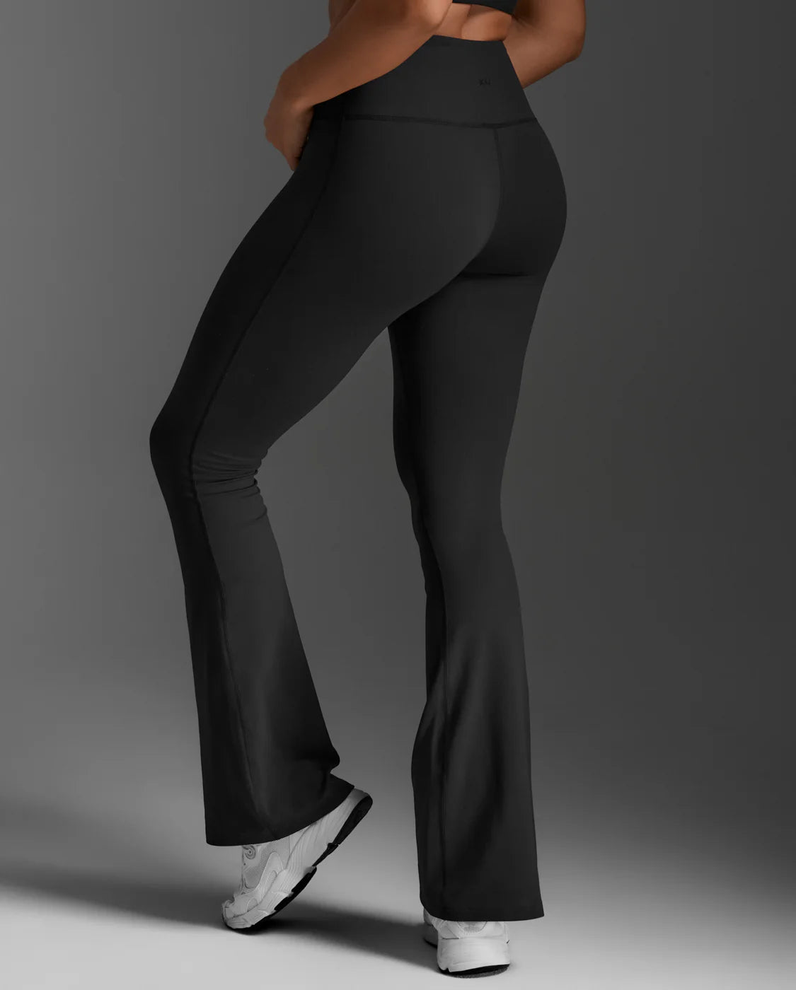 The Fluid Hi-Rise Flare Pants are made for movement that feels good and looks even better. Crafted from sweat-wicking nylon 6.6 with four-way stretch, they offer support, flow, and all-day comfort. A sculpted high-rise waistband holds firm, while the flare silhouette elongates and flatters. The seamless front panel and V-back shaping bring a smooth, confident finish. Whether you're training, travelling, or stepping out, these pants deliver the kind of comfort that never slows you down