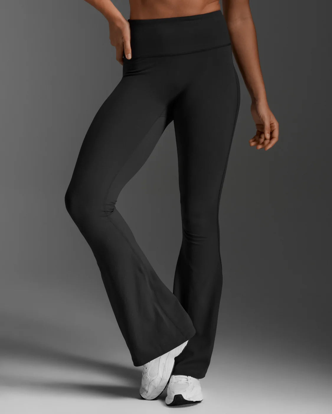 The Fluid Hi-Rise Flare Pants are made for movement that feels good and looks even better. Crafted from sweat-wicking nylon 6.6 with four-way stretch, they offer support, flow, and all-day comfort. A sculpted high-rise waistband holds firm, while the flare silhouette elongates and flatters. The seamless front panel and V-back shaping bring a smooth, confident finish. Whether you're training, travelling, or stepping out, these pants deliver the kind of comfort that never slows you down