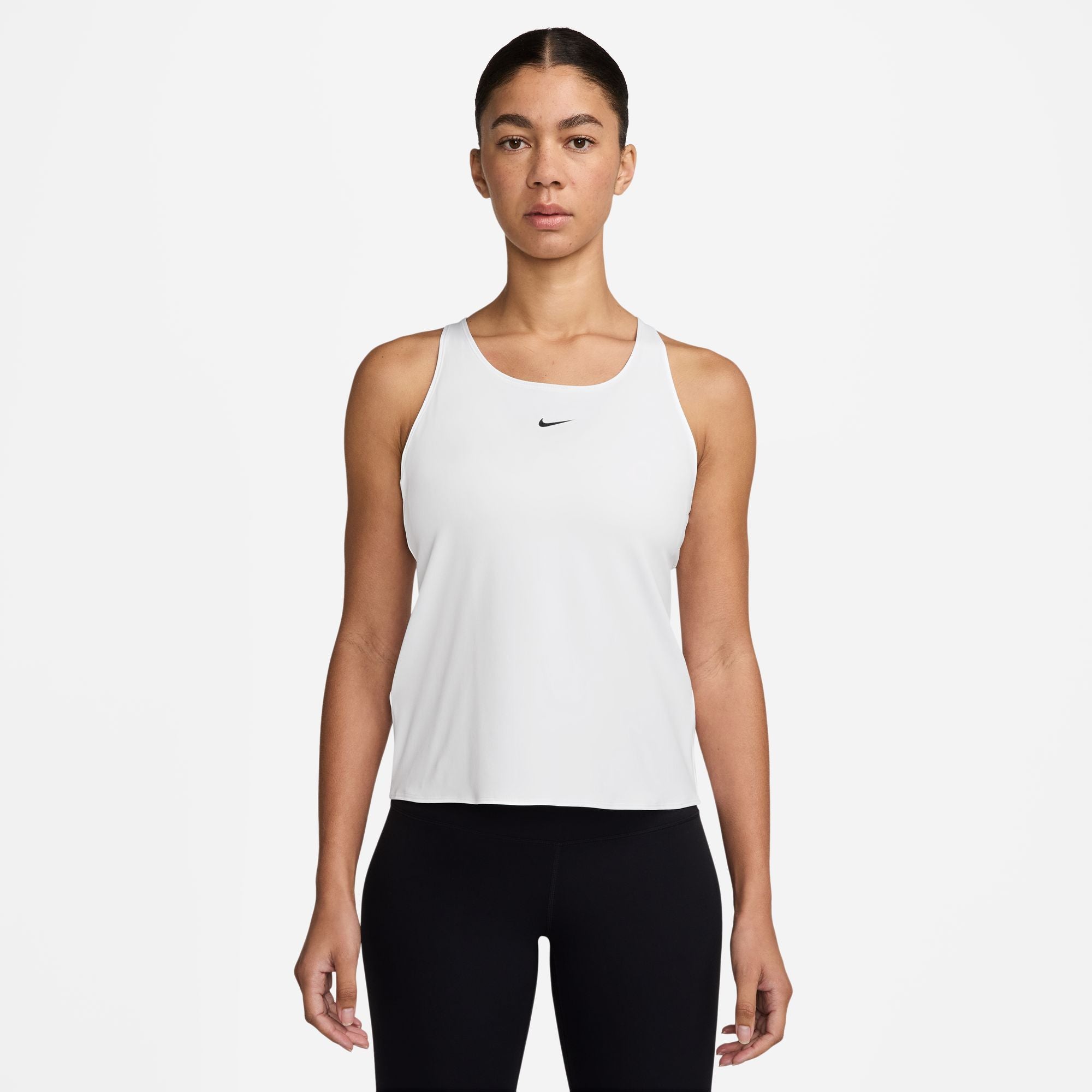 Woman wearing a white Nike tank top on a white background