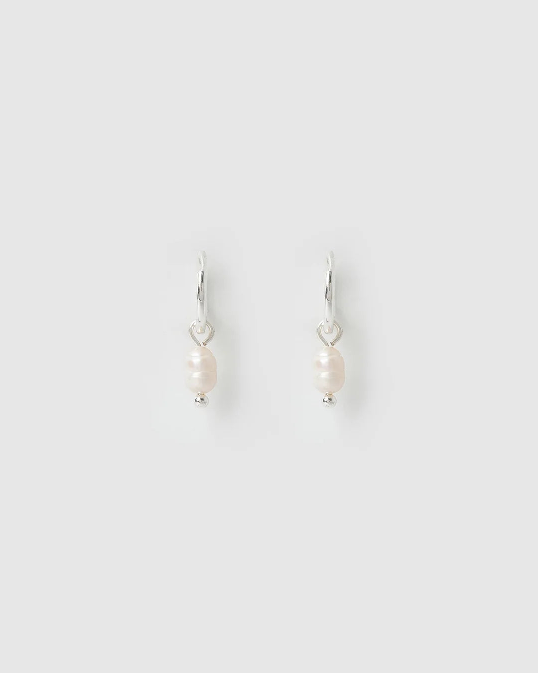 With a delicate pearl drop suspended from a classic silver huggie, Cordelia are easy to stack and style to reflect your unique look.