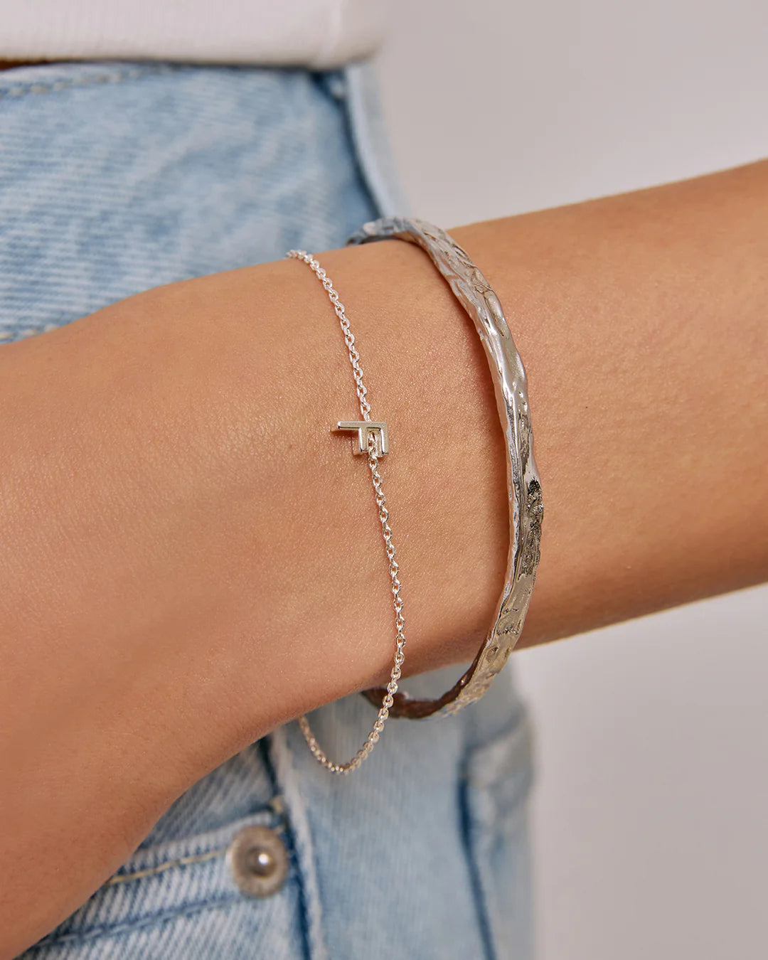 Crafted with a cool crushed silver texture and a refined, malleable shape, the Helios Cuff is the epitome of understated luxury