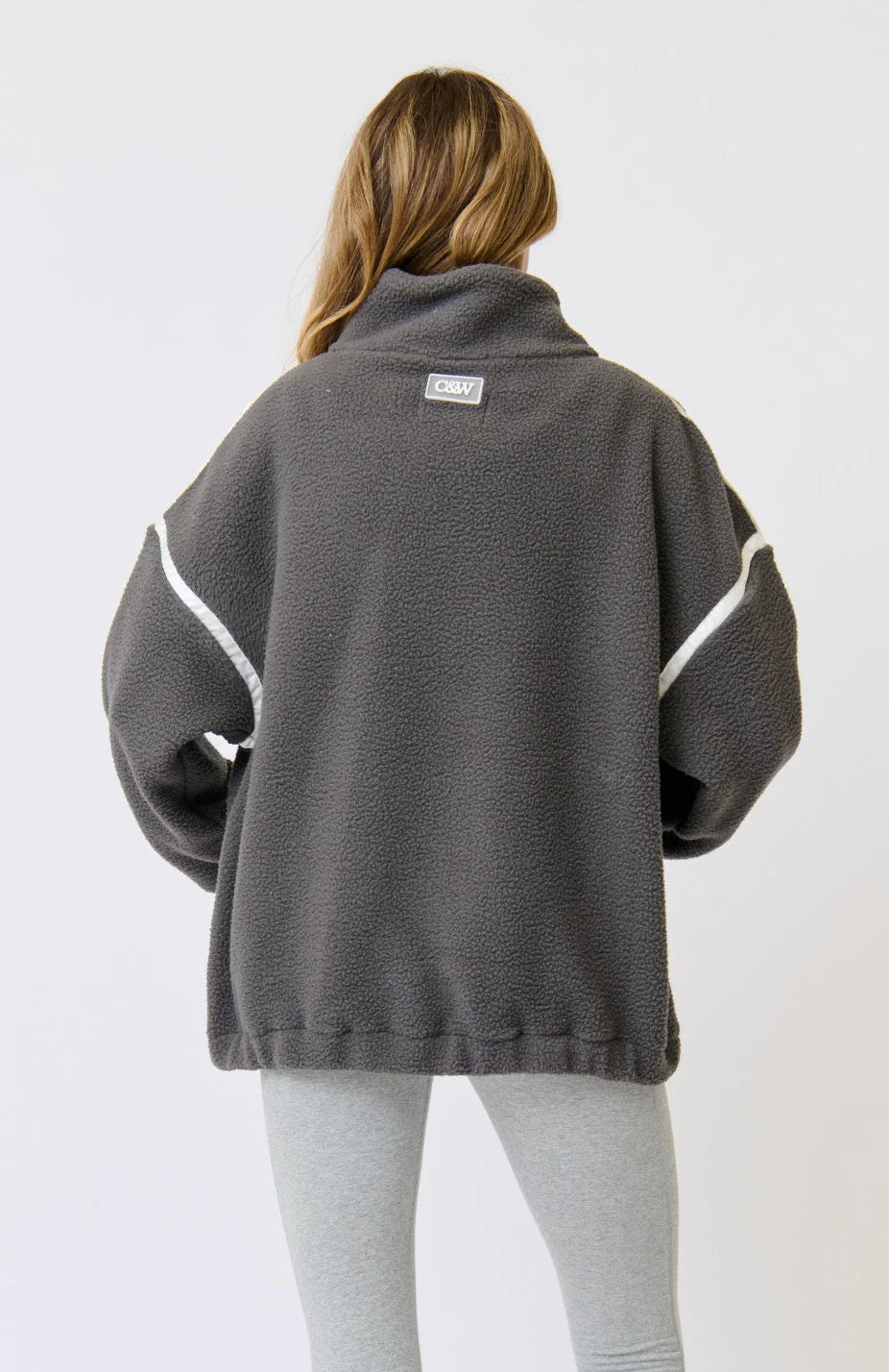 Oversized 1/4 zip pullover
Funnel neck
Ribbed cuffs
Encased elastic through the hem
Drop shoulder with long sleeve
Contrast nylon binding along shoulders and zip
Welt pockets
100% Polyester fleece fabric