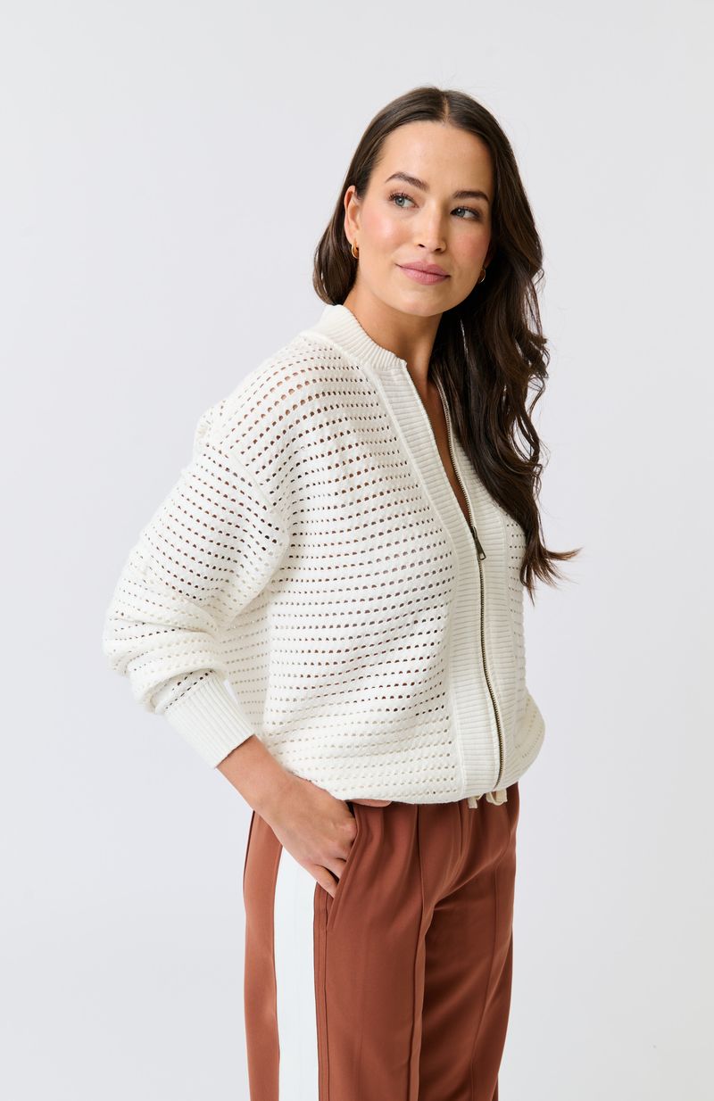 Knit bomber style zip through jacket
Open pointelle knit pattern
Ribbed neck, hemline, sleeve cuffs and zipper placket
Dropped shoulder with long sleeves
Designed to be turned up at the hem for a relaxed look
75% viscose, 25% polyester knit fabric