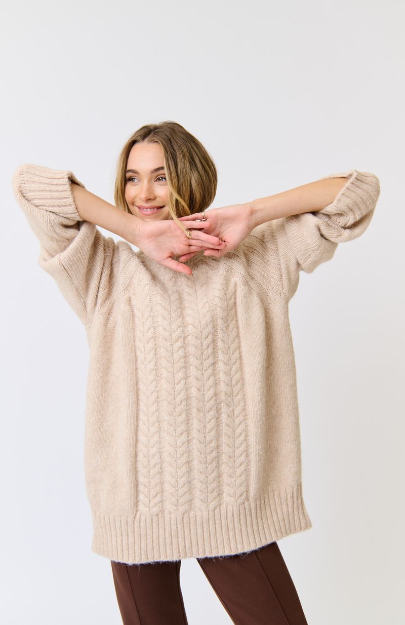 Longline, funnel neck sweater
Allover cable knit pattern
Rib knit sleeve cuffs and hem
Oversized fit through the body
100% Recycled Polyester