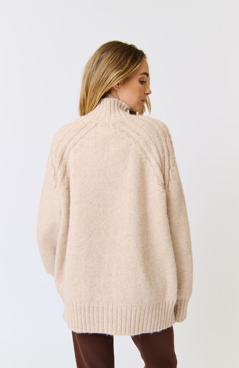 Longline, funnel neck sweater
Allover cable knit pattern
Rib knit sleeve cuffs and hem
Oversized fit through the body
100% Recycled Polyester