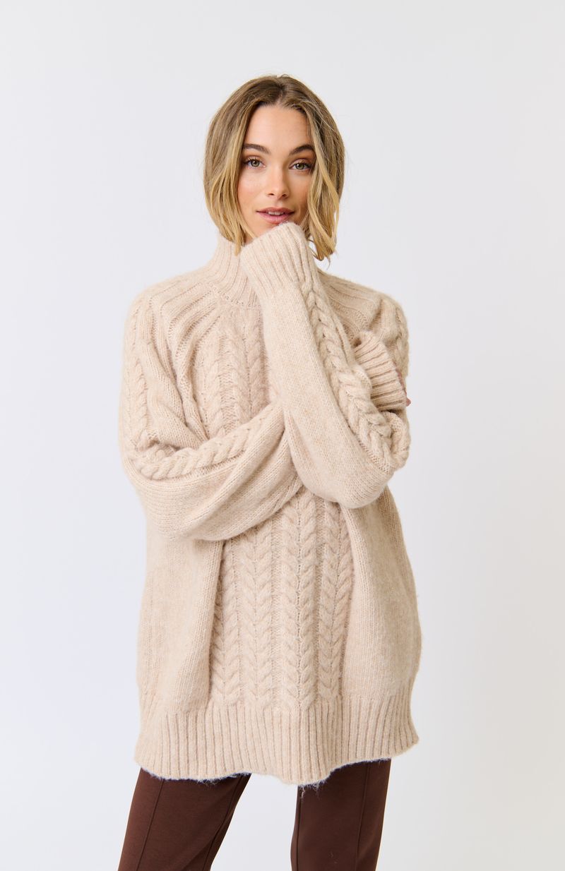 Longline, funnel neck sweater
Allover cable knit pattern
Rib knit sleeve cuffs and hem
Oversized fit through the body
100% Recycled Polyester