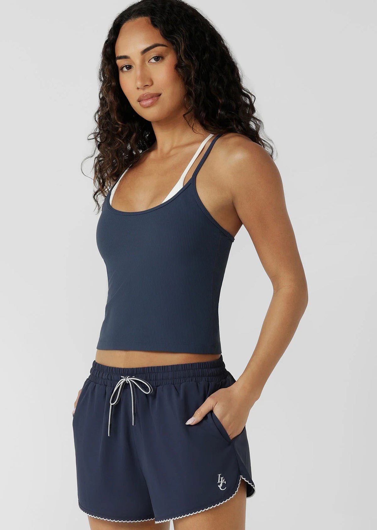 Built In Shelf Bra with Removable Padding for All Day Support
Fashion Forward Layered Look Design
Form Flattering Full Length Fitted Silhouette
Sweat wicking Luxe Active Rib Fabrication
Woven Logo Badge