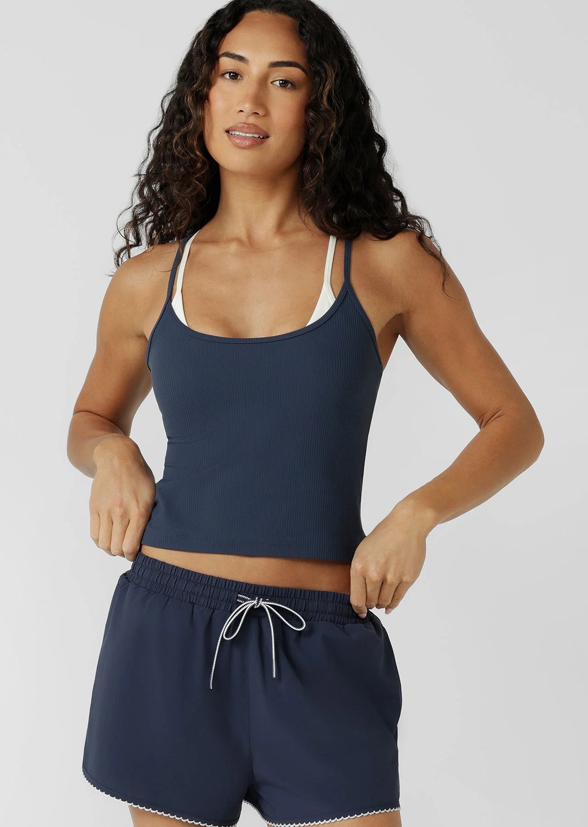 Built In Shelf Bra with Removable Padding for All Day Support
Fashion Forward Layered Look Design
Form Flattering Full Length Fitted Silhouette
Sweat wicking Luxe Active Rib Fabrication
Woven Logo Badge