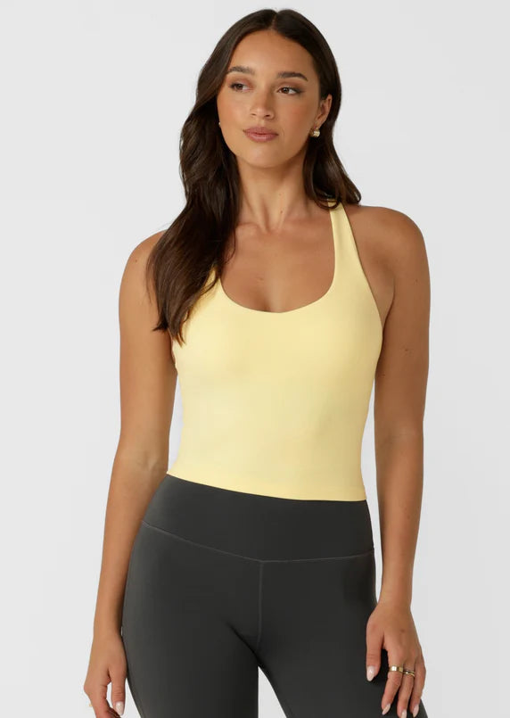 Built in Shelf Bra with Removable Padding for All Day Support
Form Flattering Cropped Fitted Silhouette
Supportive Racerback Silhouette Clears the Shoulder Blades
