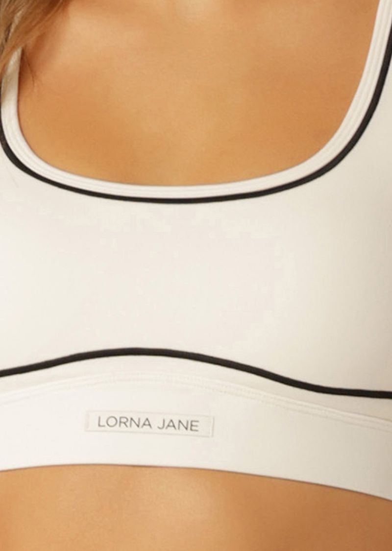 Compressive and Adjustable Hem Band for High Support
Keyhole Back Design for Added Ventilation
Curved Underbust and Contrast Taping for a Retro Sport Look
Racerback Silhouette Clears the Shoulder Blades
LJ Rubber Logo Badge