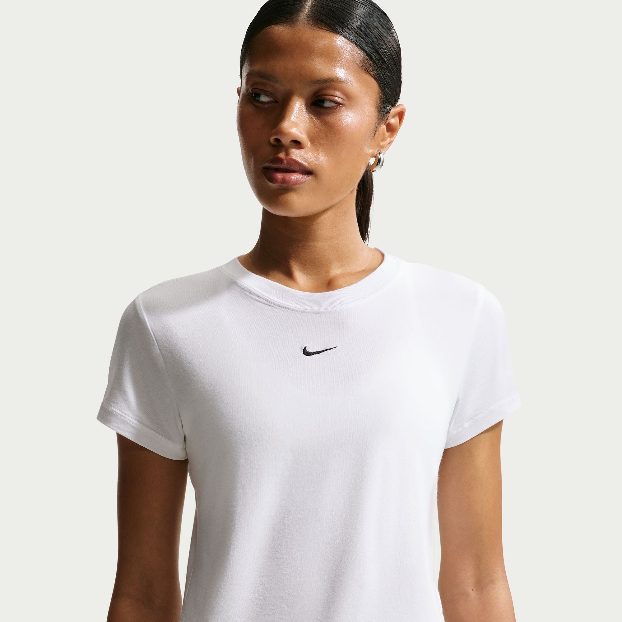 Perfect for any day, this slightly cropped, slim-fitting tee is classic and versatile. Nike's smooth jersey feels stretchy with a slight drape, giving it a comfortable, body-skimming feel.