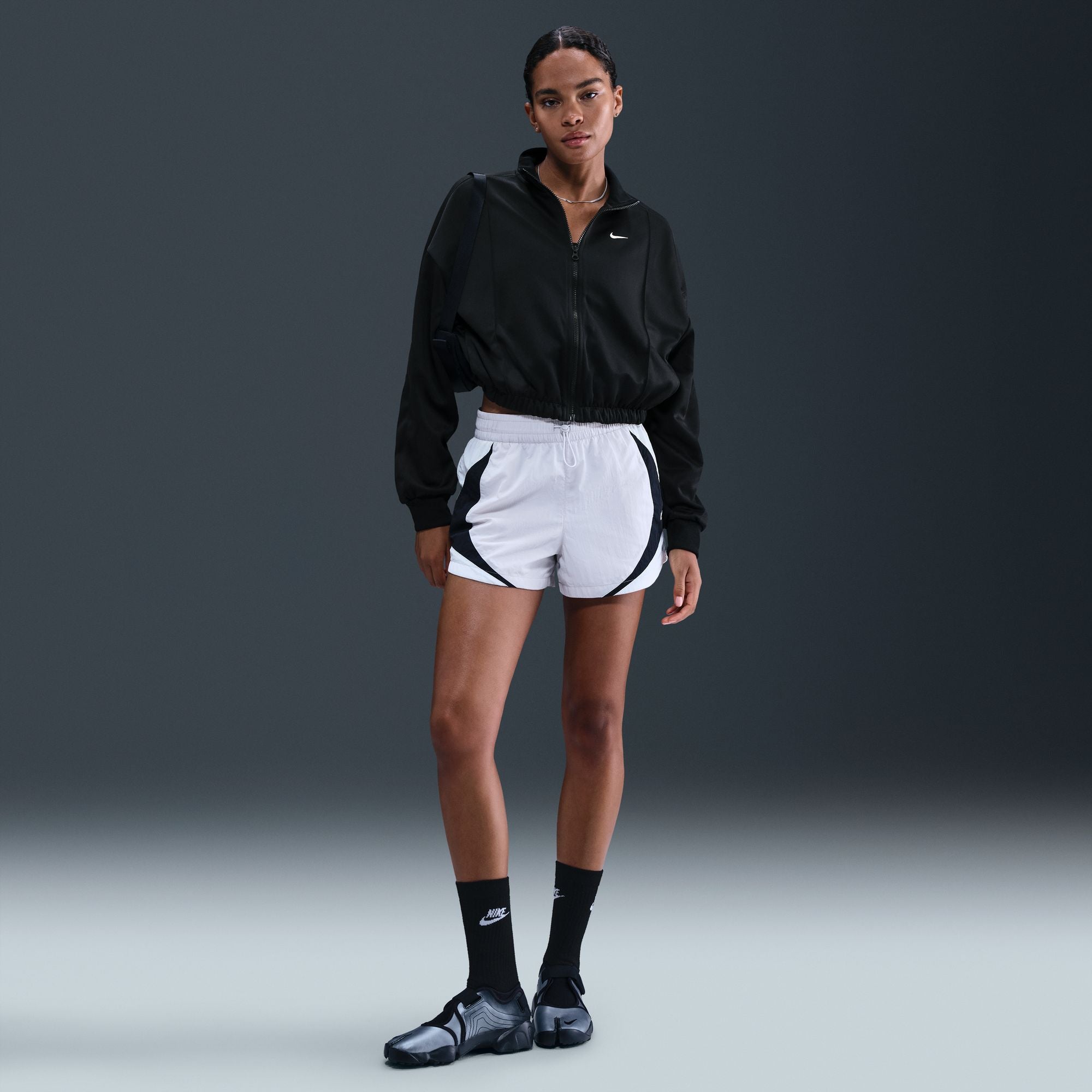 This classic track jacket is elevated through volume and drape. Elastic at your waist cinches in the oversized and slightly cropped silhouette.