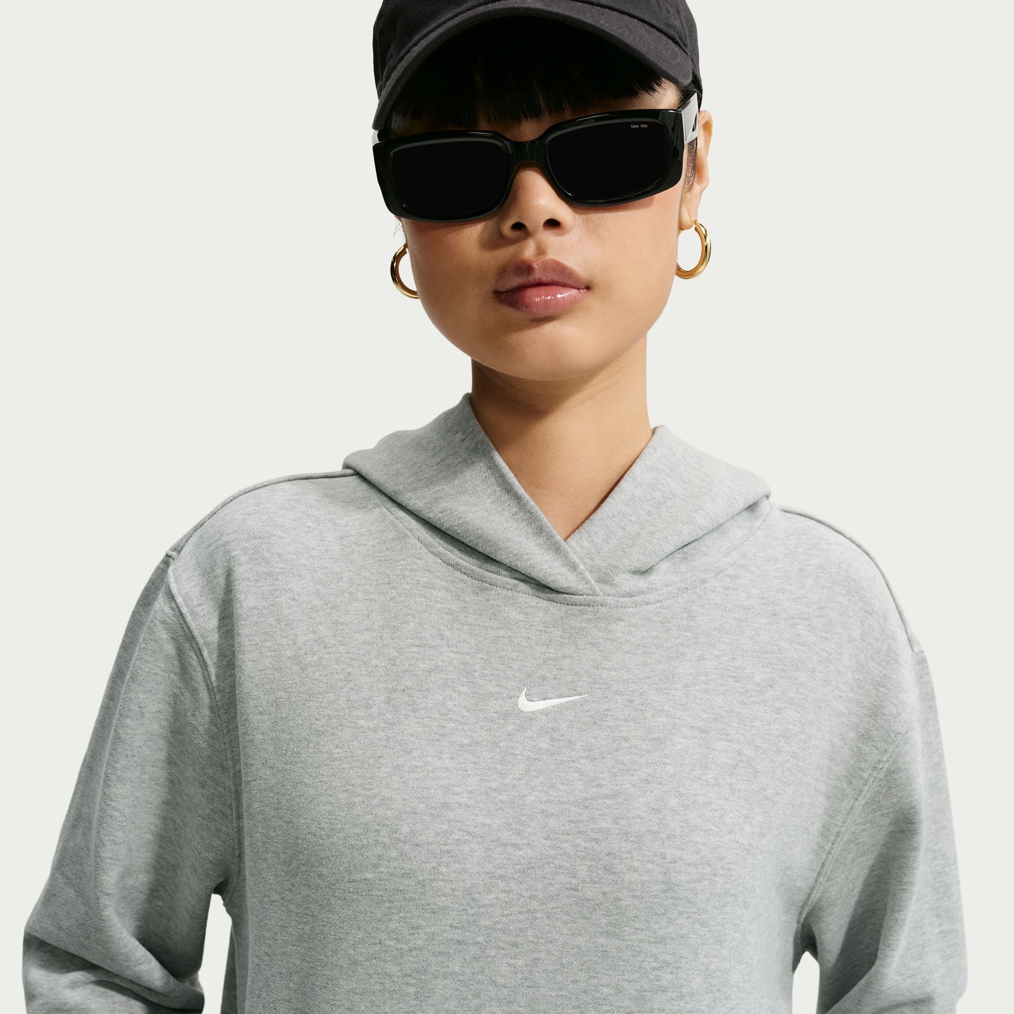Person wearing a grey Nike hoodie