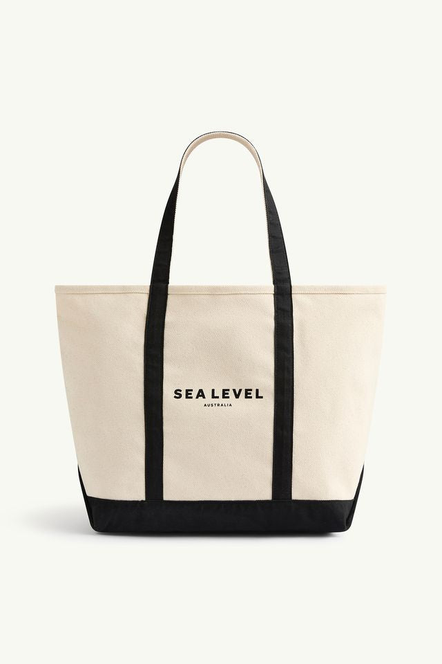 Heavy weight cotton canvas
Double handle
Sea Level logo print
Gold logo pin
Base and handle contrast
Internal pocket
Hard base
Large tote size