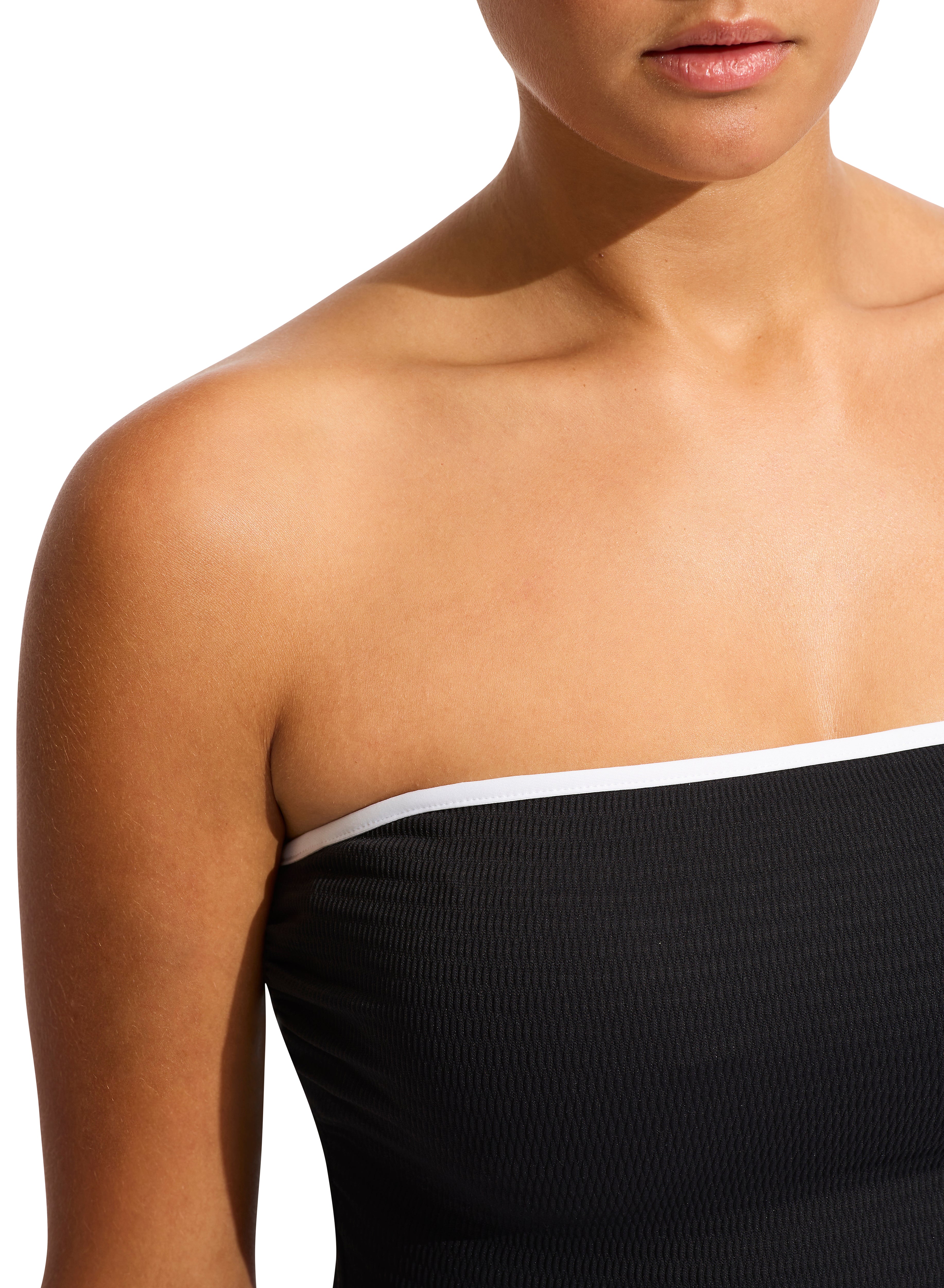 The DD Bandeau One Piece features an internal shelf bra, hidden underwire, gripper tape, removable & adjustable straps, high legline, contrast bin