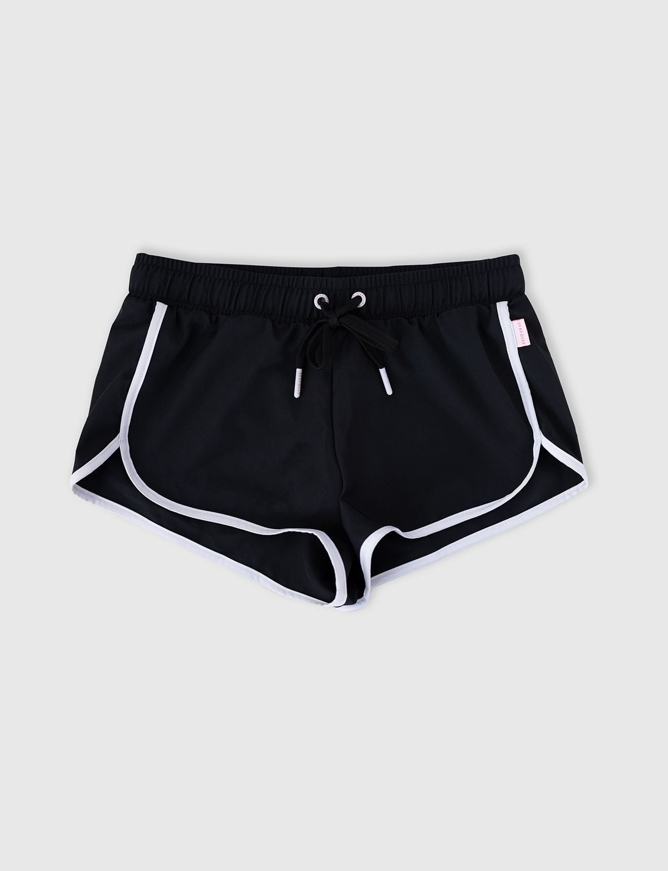 Seafolly Girls Essentials Boardshort in Black features an elasticated waistband, draw cord, scallop hemline, contrast piping.