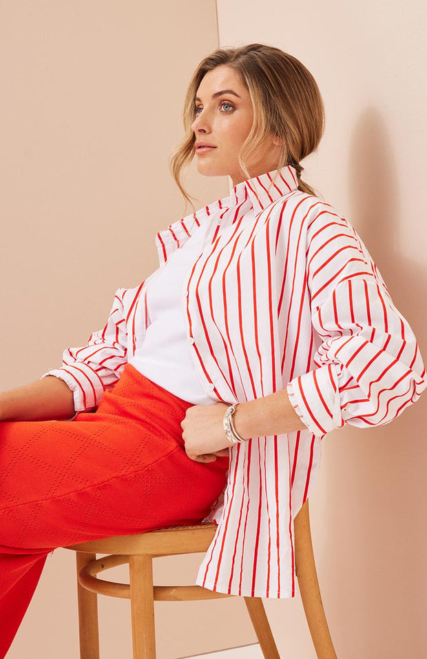 Oversized fit, button front shirt Longline, curved hemline Full length sleeve with button cuff Fine striped pattern in Campari and White 100% soft cotton poplin fabric Chantelle wears a size small and is 173cm tall Balance 2023 collection