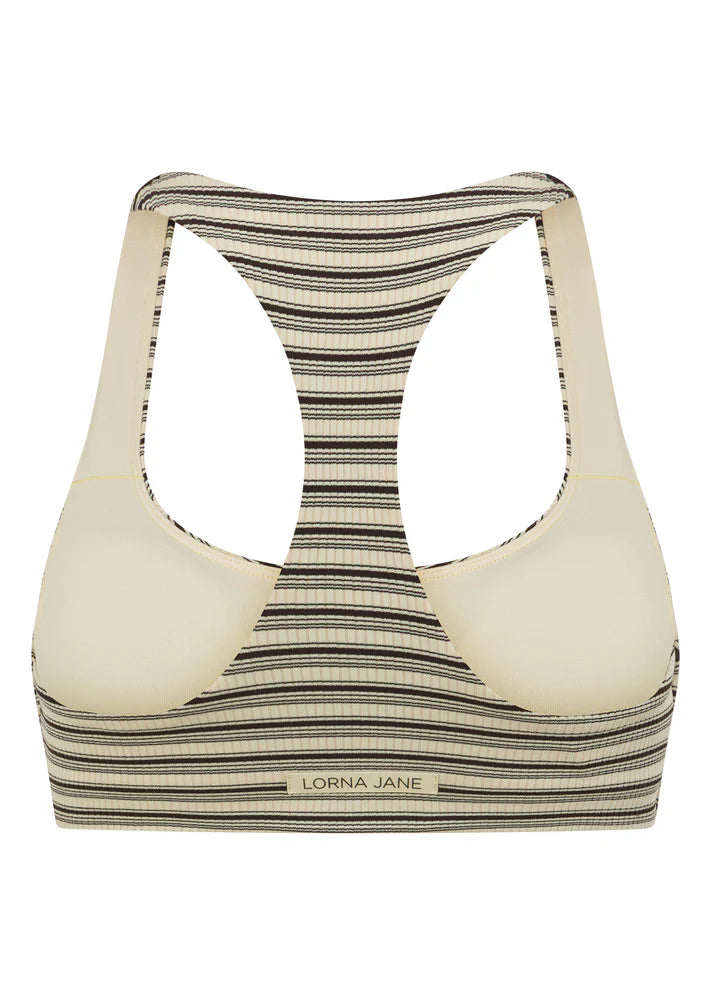 Racerback Silhouette that Clears the Shoulder Blades provides All Day Support
Premium Luxe Active Rib in a Fashion Forward Striped Design
Removable Padding for Added Shape and Support
LJ Rubber Logo Badge