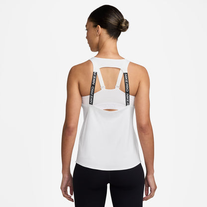 Woman wearing a white Nike tank top with cut-out design on a white background
