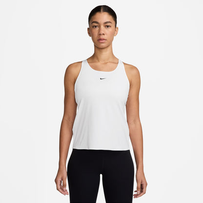 Woman wearing a white Nike tank top on a white background