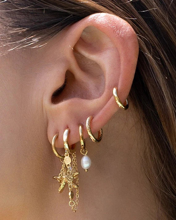 With a delicate pearl drop suspended from a classic gold huggie, Cordelia are easy to stack and style to reflect your unique look.