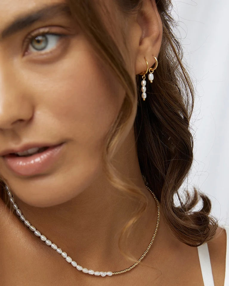 With a delicate pearl drop suspended from a classic gold huggie, Cordelia are easy to stack and style to reflect your unique look.