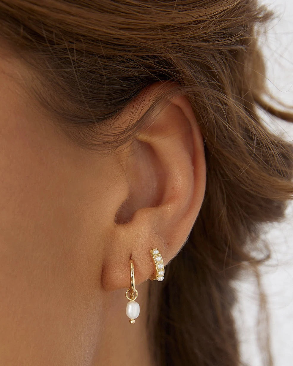 With a delicate pearl drop suspended from a classic gold huggie, Cordelia are easy to stack and style to reflect your unique look.