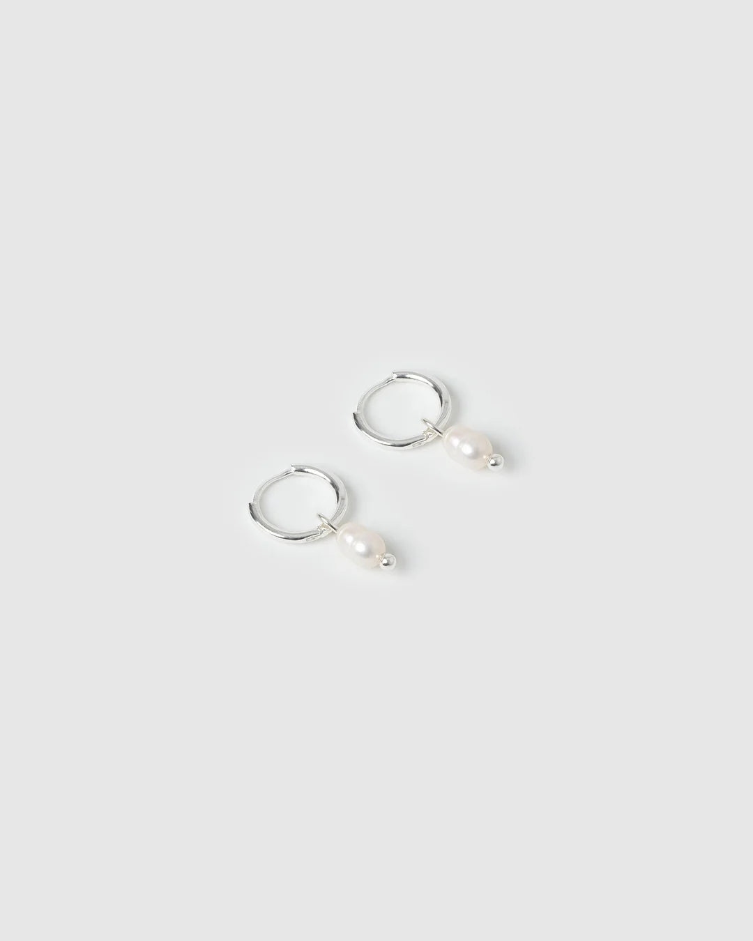 With a delicate pearl drop suspended from a classic silver huggie, Cordelia are easy to stack and style to reflect your unique look.