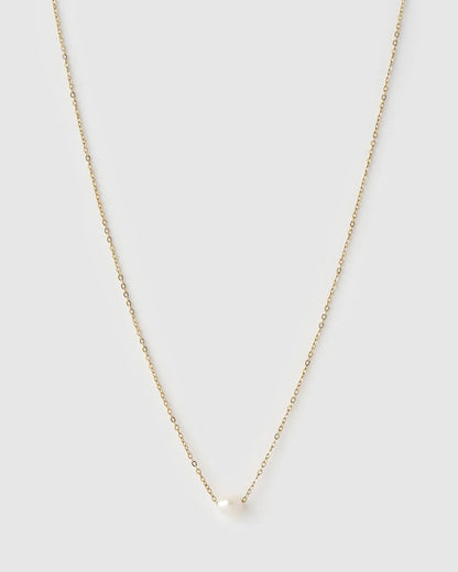 A delicate gold chain necklace with a small, round white pearl pendant, displayed against a solid light gray background.
