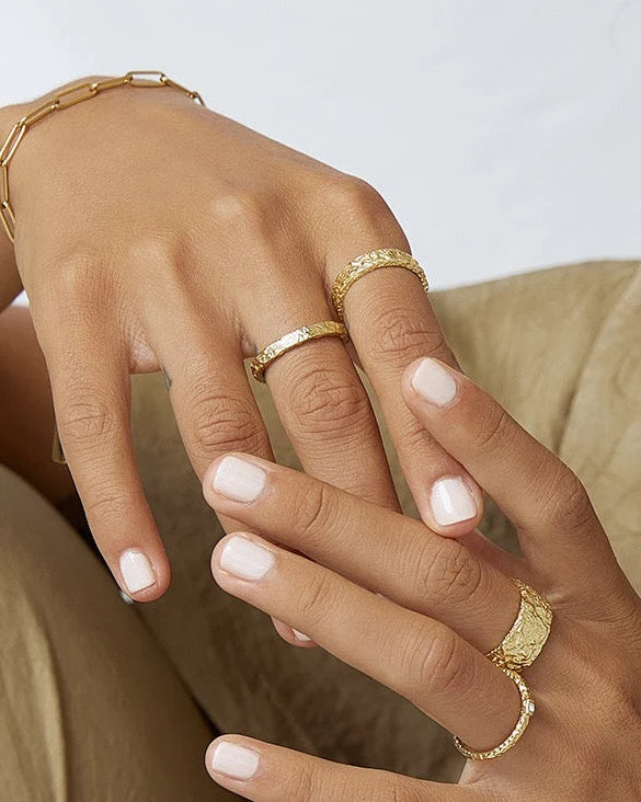 The Small Eros Textured Ring is a true beauty, both to wear and to style. With its shimmering textured surface and sleek design, it's the perfect piece to elevate your ring stack.