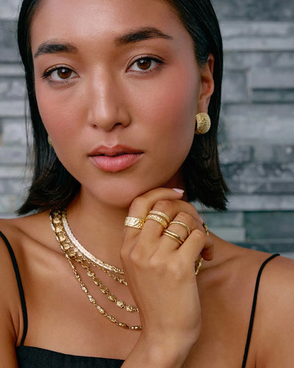 The Small Eros Textured Ring is a true beauty, both to wear and to style. With its shimmering textured surface and sleek design, it's the perfect piece to elevate your ring stack.