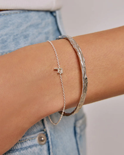 Crafted with a cool crushed silver texture and a refined, malleable shape, the Helios Cuff is the epitome of understated luxury