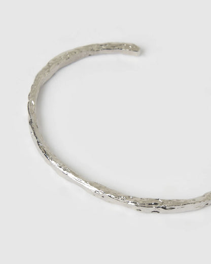Crafted with a cool crushed silver texture and a refined, malleable shape, the Helios Cuff is the epitome of understated luxury