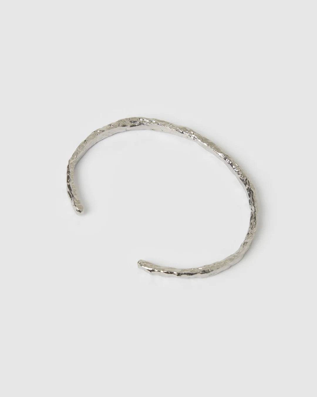 Crafted with a cool crushed silver texture and a refined, malleable shape, the Helios Cuff is the epitome of understated luxury