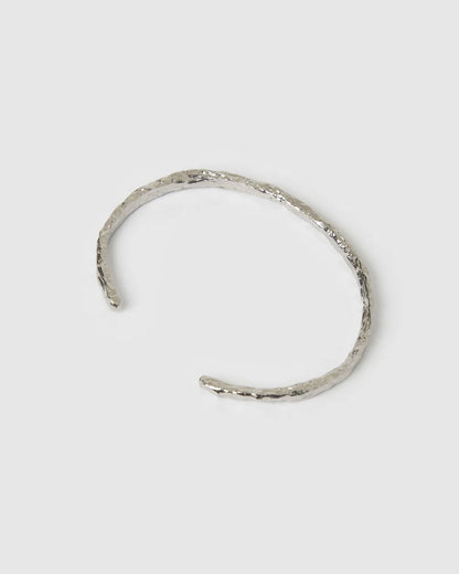 Crafted with a cool crushed silver texture and a refined, malleable shape, the Helios Cuff is the epitome of understated luxury