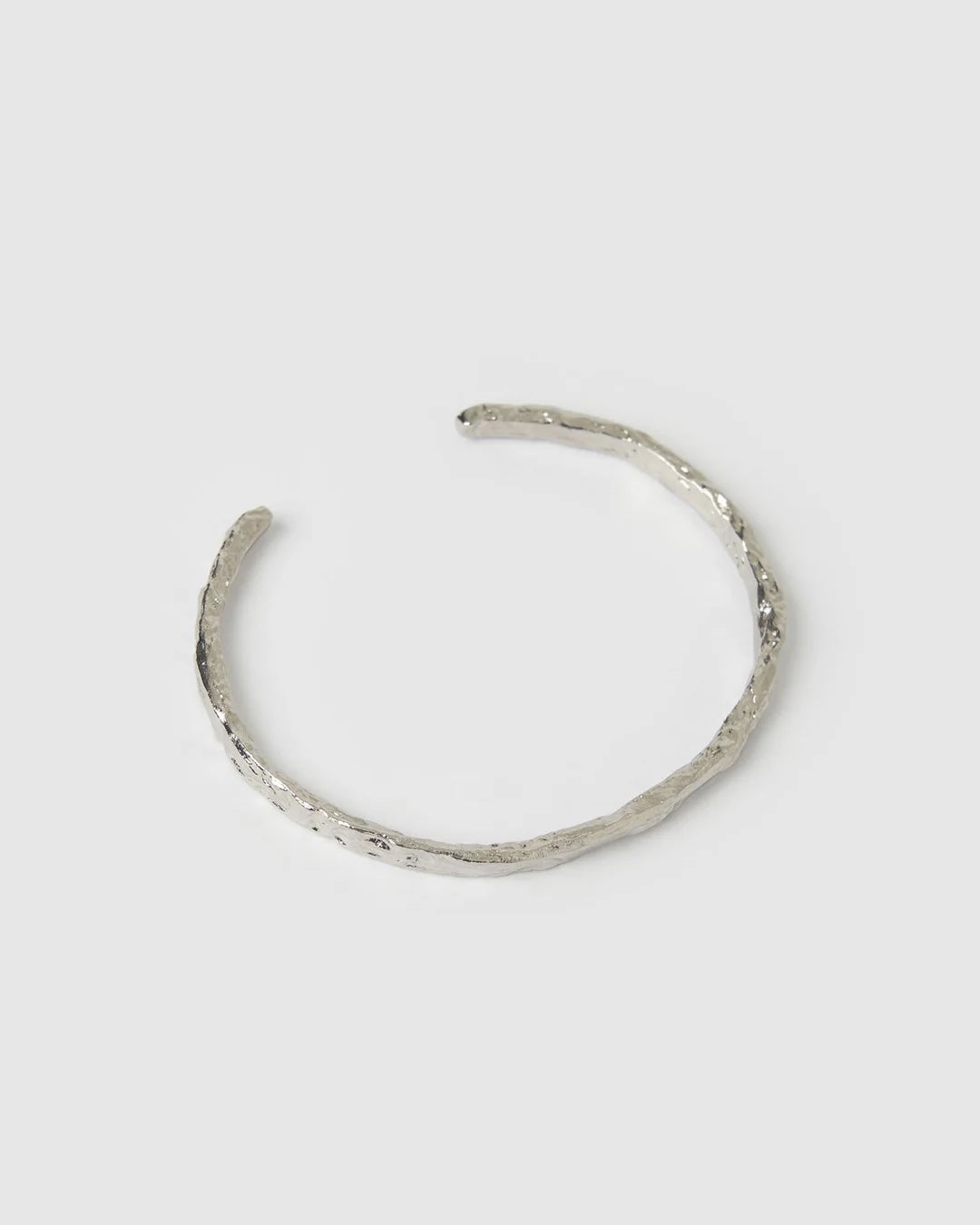 Crafted with a cool crushed silver texture and a refined, malleable shape, the Helios Cuff is the epitome of understated luxury