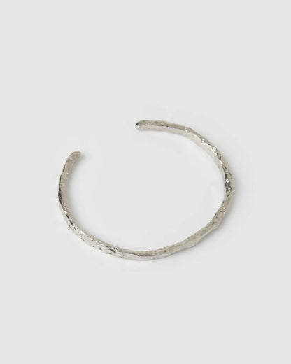 Crafted with a cool crushed silver texture and a refined, malleable shape, the Helios Cuff is the epitome of understated luxury