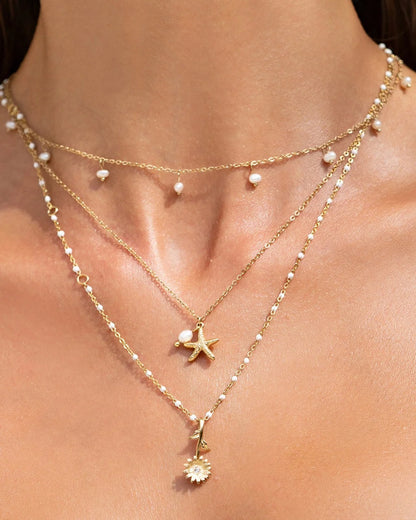 the gorgeous Laguna Necklace, with a cute starfish charm complimented by a stunning freshwater pearl. This pendant is perfect for layering with your favourite staple chain necklaces to create the perfect stack