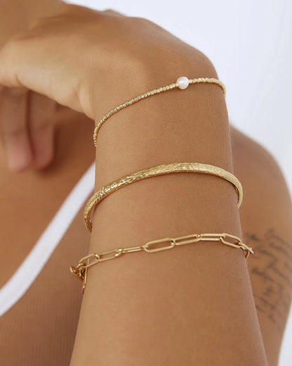 showcasing a stunning crushed gold texture, the Stevie Cuff is designed to turn heads. With its delicate silhouette, classic rounded edges, and slightly malleable fit, this dainty yet striking cuff brings effortless elegance to any jewellery collection.