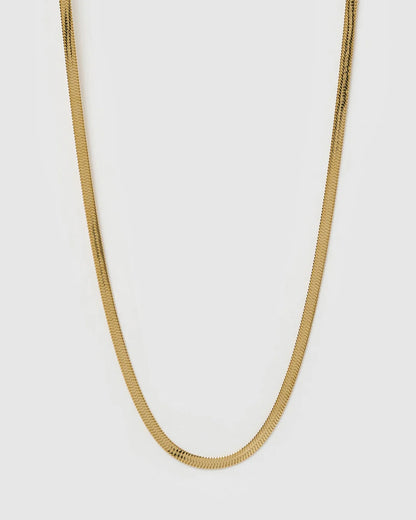 Gold chain necklace on a light gray background