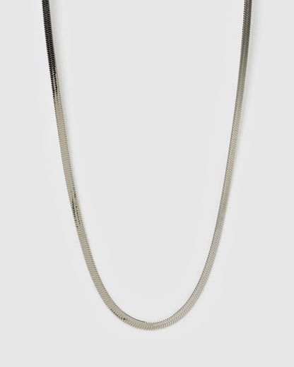 Silver chain necklace on a light gray background