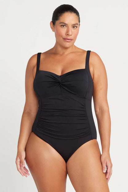 This classic best selling black one piece swimsuit silhouette is designed to fit a multitude of women and has multifit soft foam cups to fit a C - DD cup, a loop front design feature, side panels and front panel ruching for body shaping confidence.