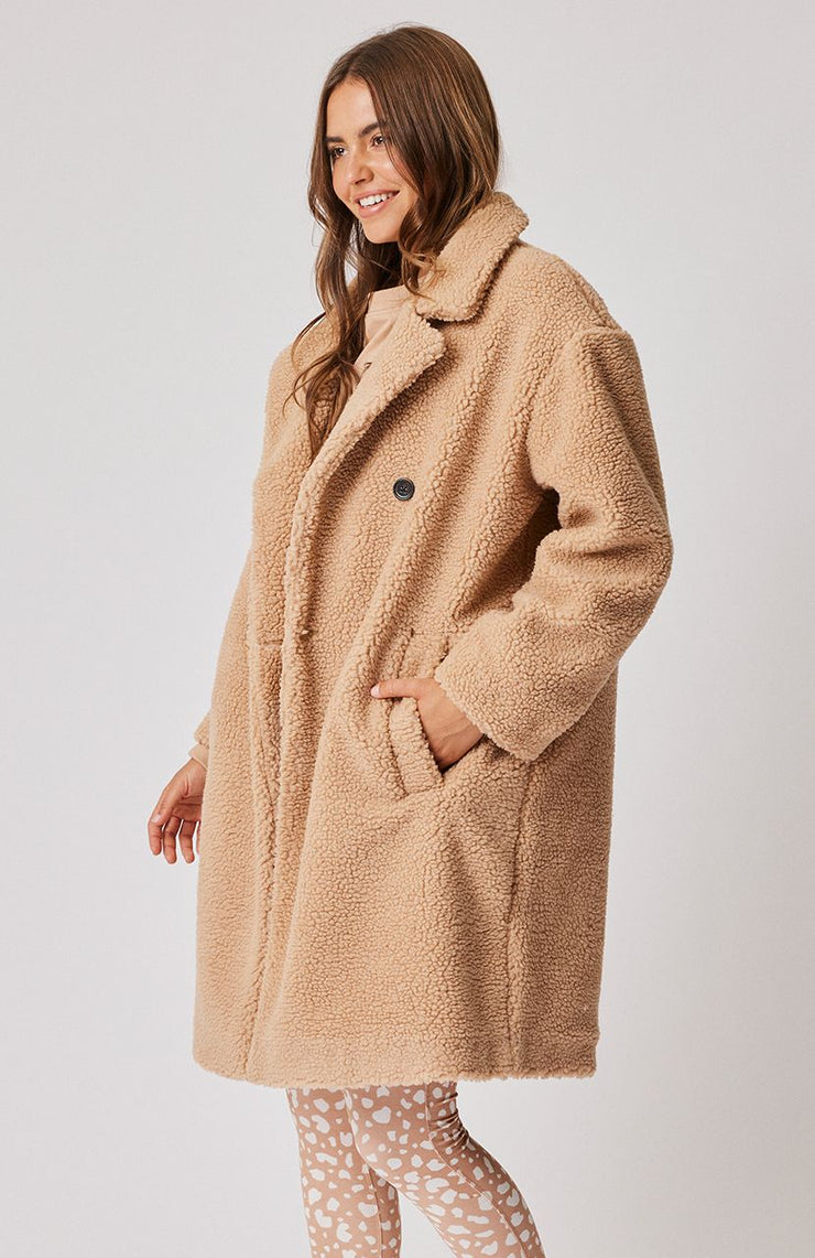 Oversized knee length coat with notched collar Feature black tortoise buttons on the front Front side pockets 100% faux sherpa fabric Leilani wears a size medium and is 177cm tall 