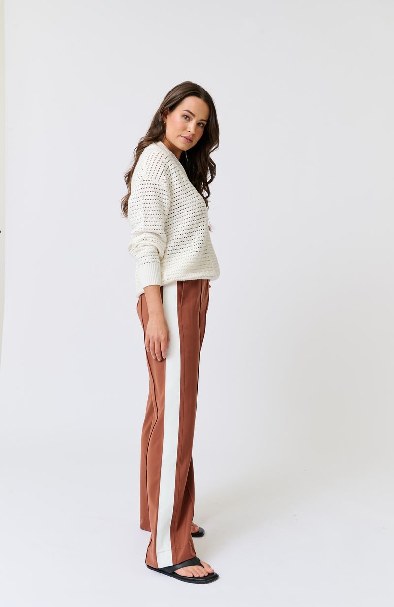 Elasticated waistband with functional drawstring
Straight leg fit
Inseam side pockets
Front and back leg pin tuck seam detailing
Contrast off white stripe grosgrain tape along outer leg 
98% Polyester, 2% spandex fabric