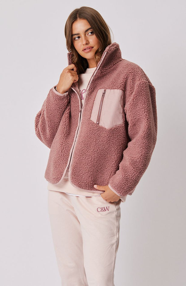 Fully lined zip-up boxy style jacket Relaxed fit through the body Contrasting front patch pocket and binding Plastic front zip Rounded front hemline shape 100% faux sherpa fabric Leilani wears a size medium and is 177cm tall Roame 2023 collection