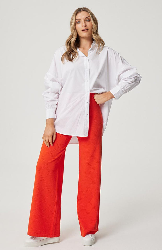 Oversized fit, button front shirt Longline, curved hemline Full length sleeve with button cuff Fine striped pattern in Campari and White 100% soft cotton poplin fabric