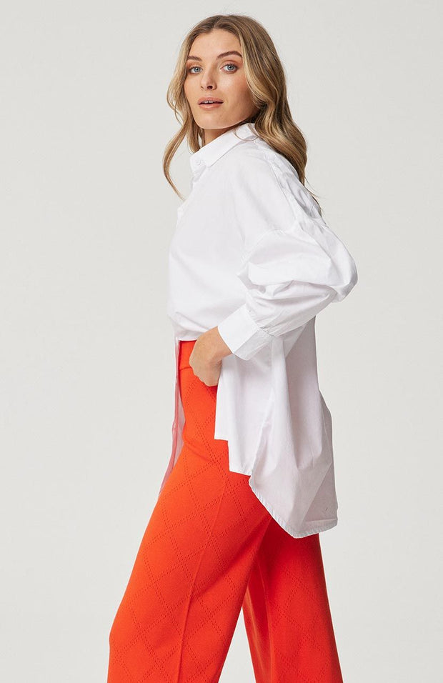 Oversized fit, button front shirt Longline, curved hemline Full length sleeve with button cuff Fine striped pattern in Campari and White 100% soft cotton poplin fabric