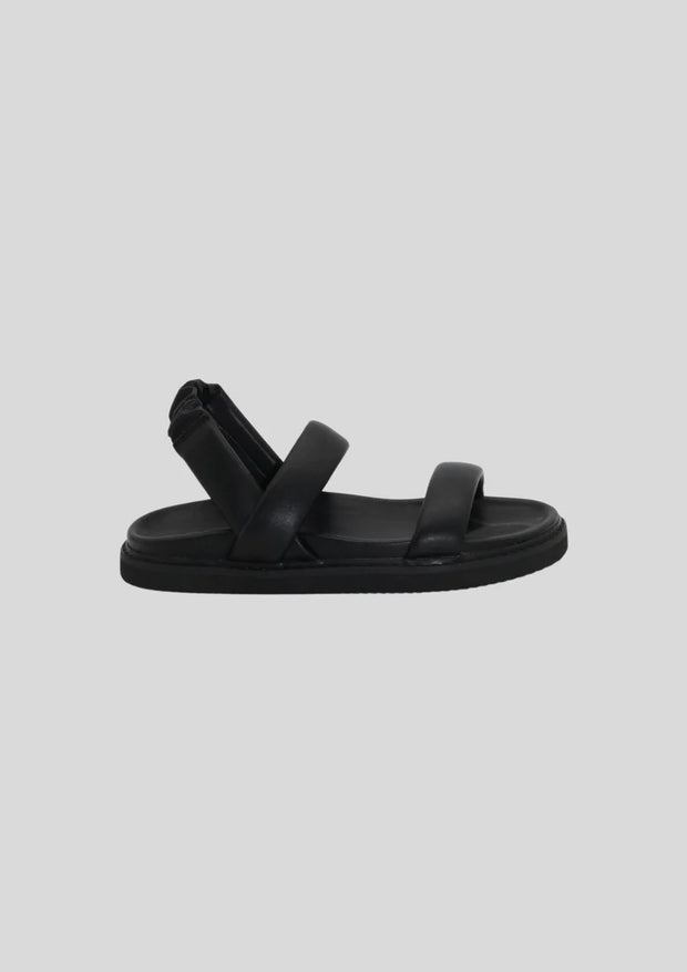 Simplistic leather sling back sandal on a soft footbed  Leather upper  Padded straps with an elastic gusset on back  1.5cm moulded sole with footbed leather lining