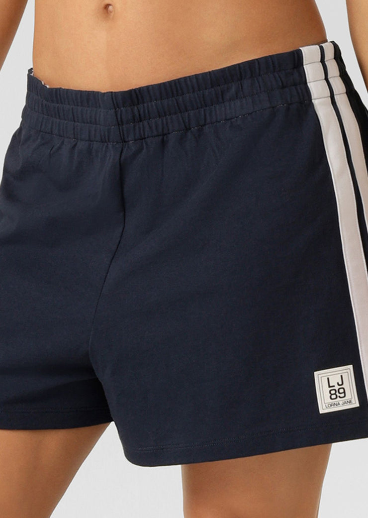 Fan-favourite alert! We're bringing back the beloved Dance Shorts to elevate your athleisure game. Designed for style and comfort, these cotton-jersey shorts feature a fold over waistband with drawcord adjustability, retro-sport inspired contrast striping down the side leg and our limited edition badge. Get it quick, this is a must-have style for summer!